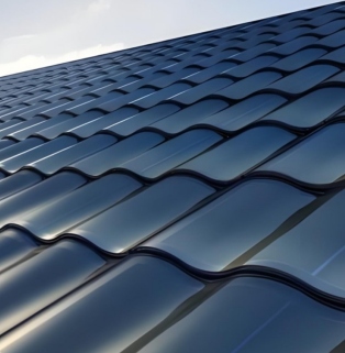 High-end villa photovoltaic roof showcases the matte texture of the deep blue three-curved Han tile, its streamlined wave design, and its seamless integration with the building's architecture.