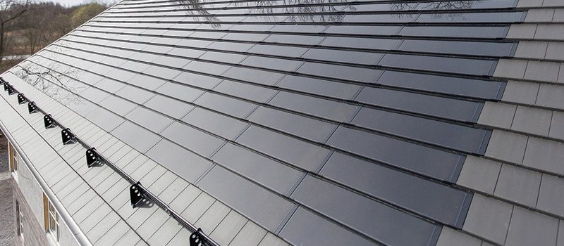 Home solar roof Renderings of a family house roof paved with solar tiles