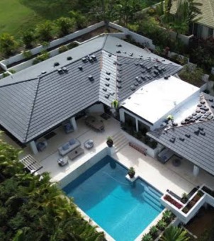 Overlooking a high-end vacation villa with a pool courtyard fitted with GreenMore solar tiles.