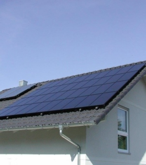 GreenMore's all-black, high-efficiency solar photovoltaic modules are installed on the sloping roofs of modern homes, providing a clean electricity solution for the home.