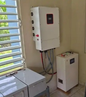 A real-life indoor installation of GreenMore's wall-mounted hybrid inverter and battery pack, showcasing the integrated photovoltaic and energy storage system architecture for homes.