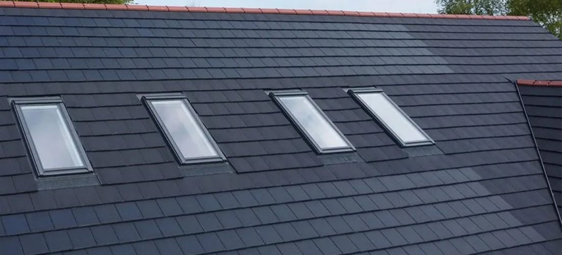 A real-life example of GreenMore's double-glazed flat-pane photovoltaic tile installation on a residential roof, showcasing the seamless BIPV (Building Integrated Photovoltaics) effect integrated with the skylight.