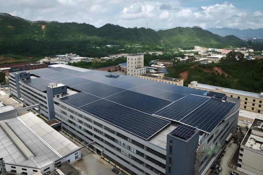 Aerial view of a BIPV rooftop system at a Malaysian factory, showcasing a large-scale industrial and commercial photovoltaic array laid out on the factory floor.