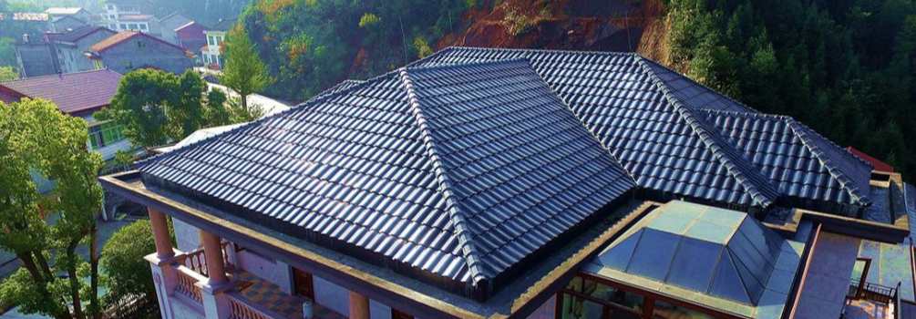Real-life photo of GreenMore residential multi-sloped roofs covered with dark blue triple-curved arched solar tiles.